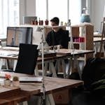 Open-plan office with modern decor and natural lighting, ideal for productivity.